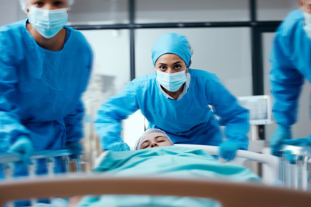 Surgeon, bed and rush in a hospital for emergency operation in the er with a sick patient. Surgery
